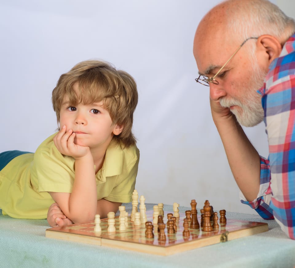 Chess competition. Little boy thinking about next move in game of chess. Board games. Gran