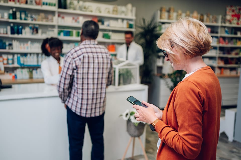 A pharmacist helping a customer at the pharmacy counter