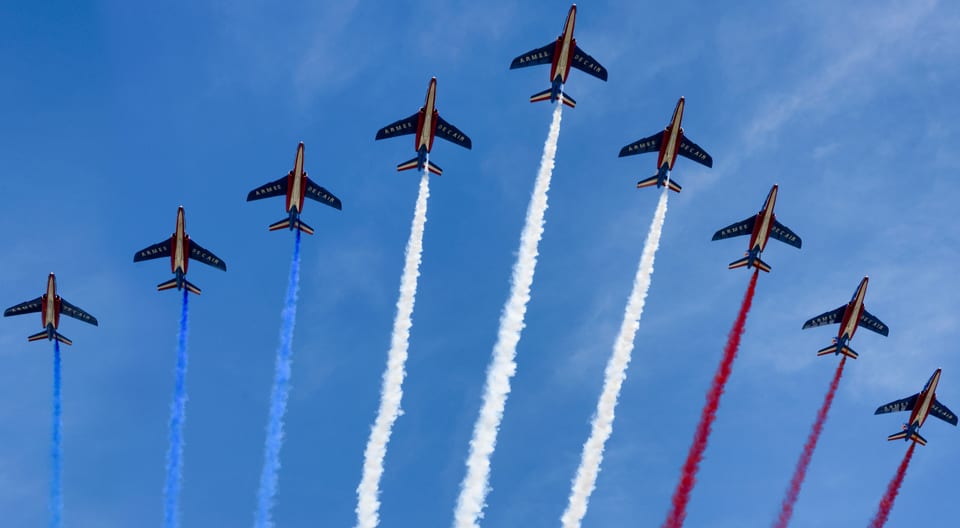 Jets flying in formation trailing red, white and blue smoke